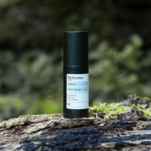 Lade das Bild in den Galerie-Viewer, Product shot of ReGlow – Face Serum standing on a moss covered tree trunk
